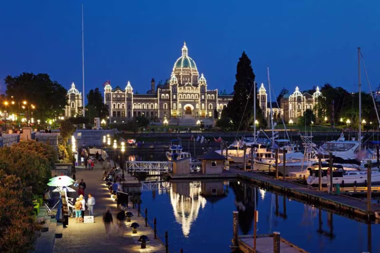 Victoria harbour and illuminated parliament at twilight in Victoria Vancouver Island Canada North America